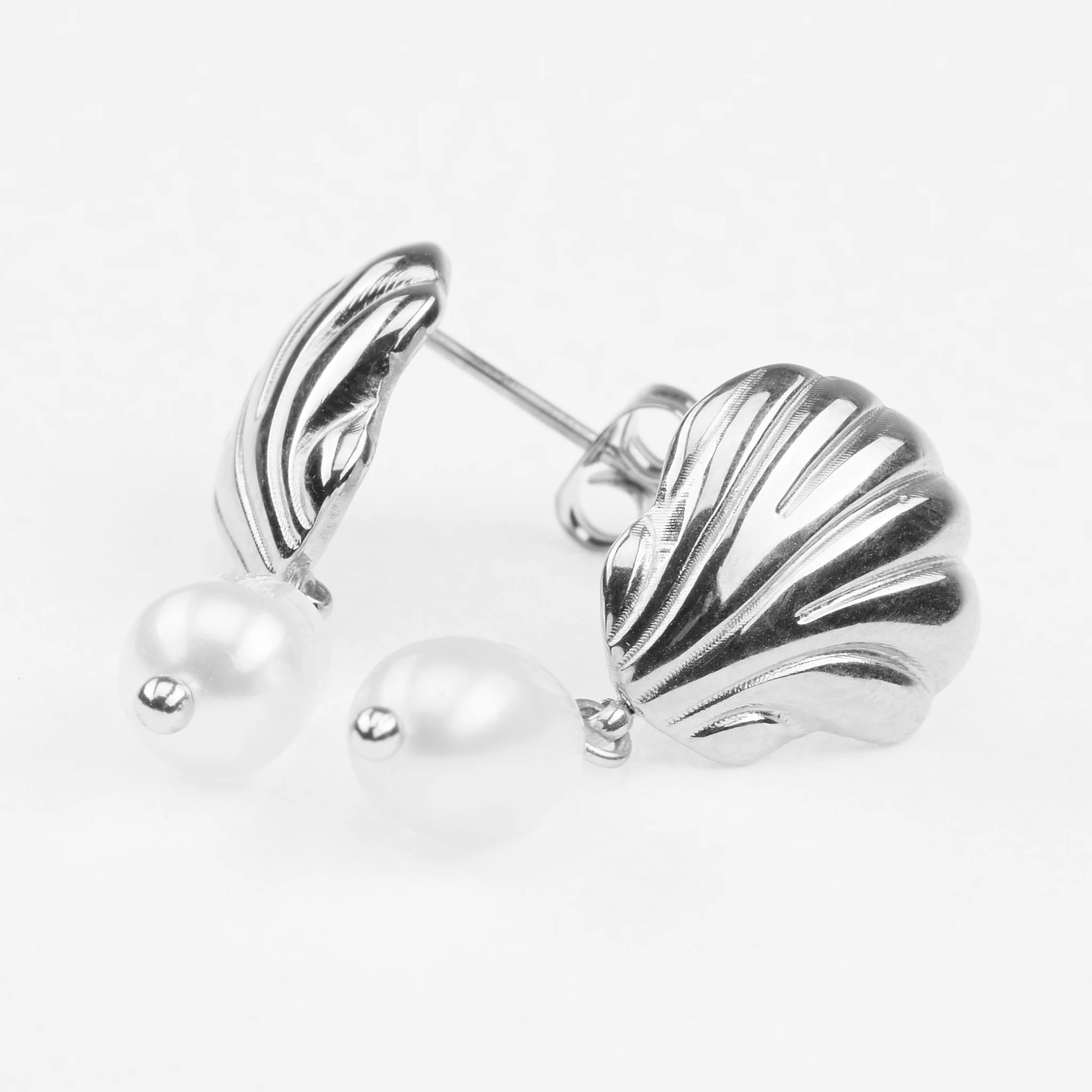 Achivada sølvøreringe i muslingeform med ferskvandsperle